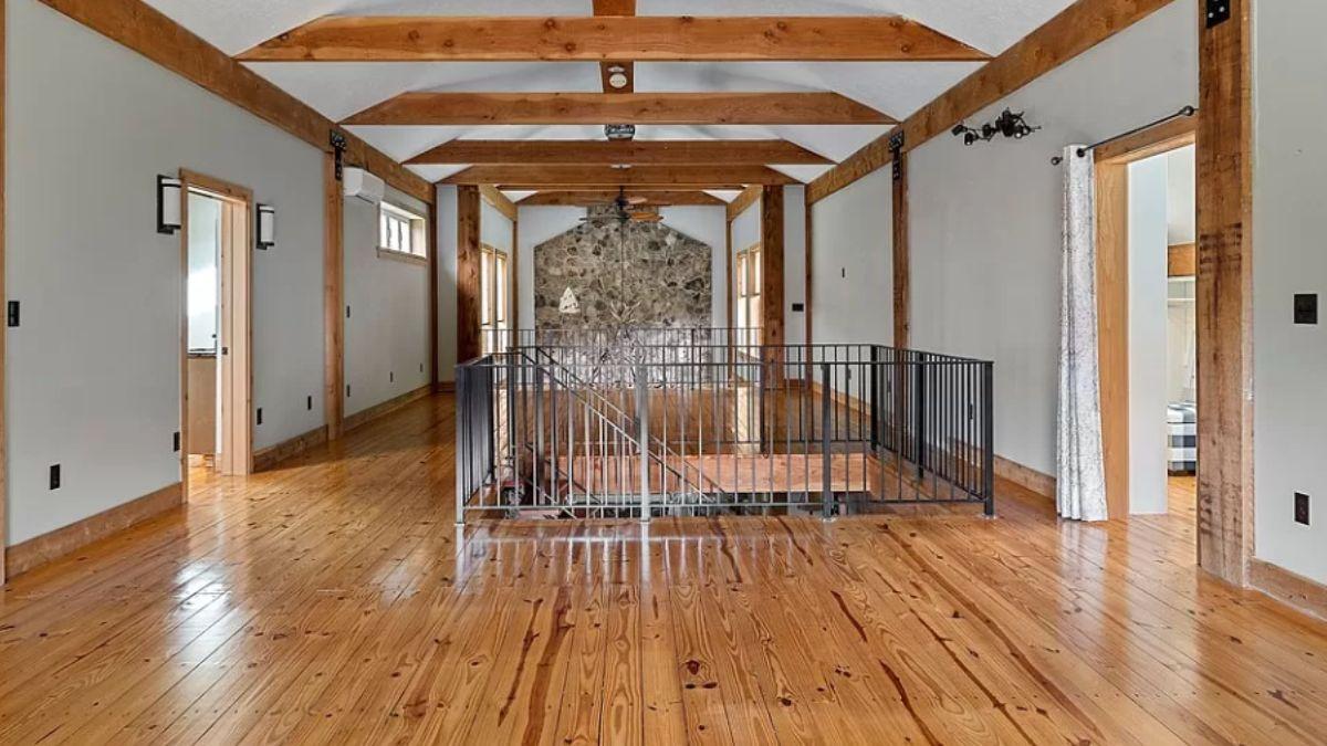 Wow, Look at the Exposed Beams and Stone Accent Wall in This Hallway