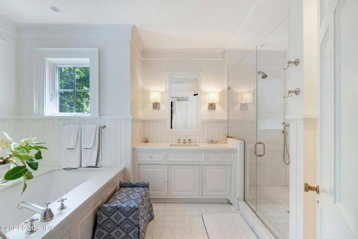 Bask in the Elegance of This Pristine Bathroom with Thoughtful Wainscoting