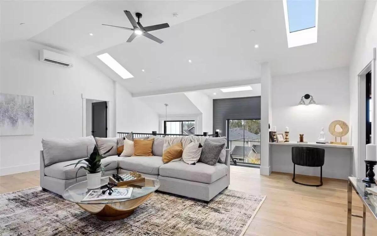 Spacious Loft Living Room with Skylights and Cozy Accents