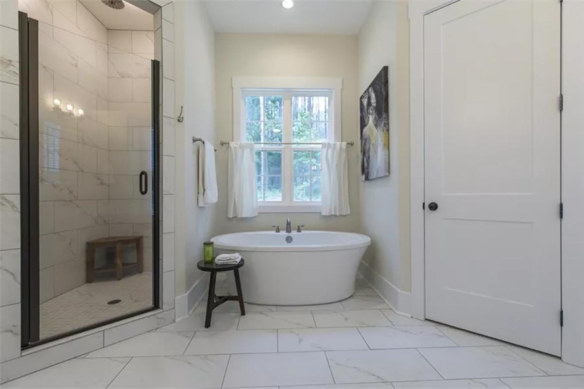 Freestanding Tub and Marble Tile Create Tranquility in the Bathroom