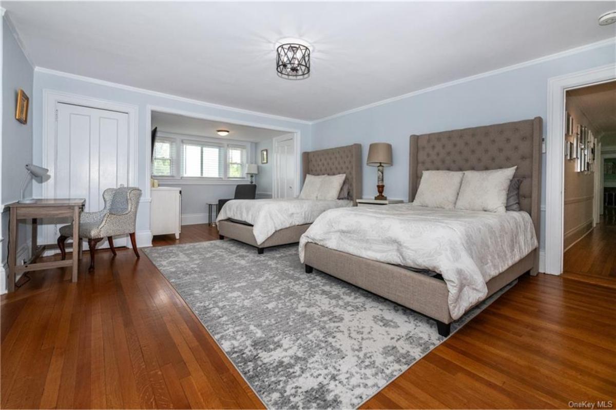 Check Out the Twin Beds and Classic Desk in This Spacious Bedroom