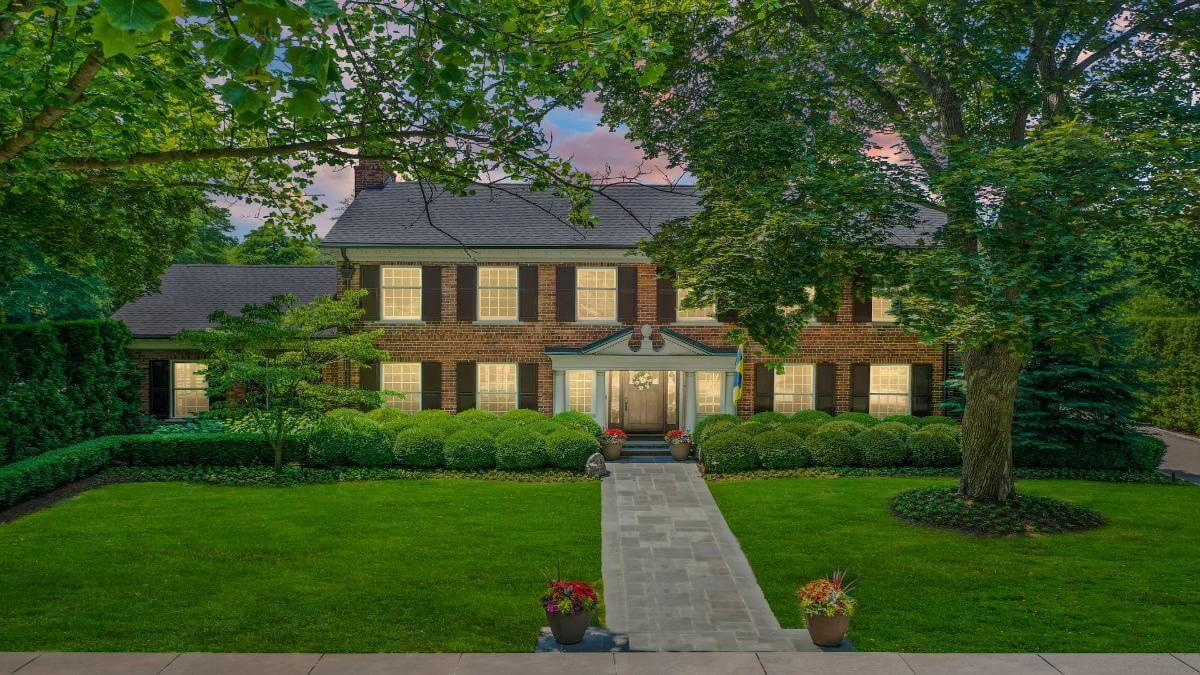 Stately Brick Facade with Classic Charm and Manicured Gardens
