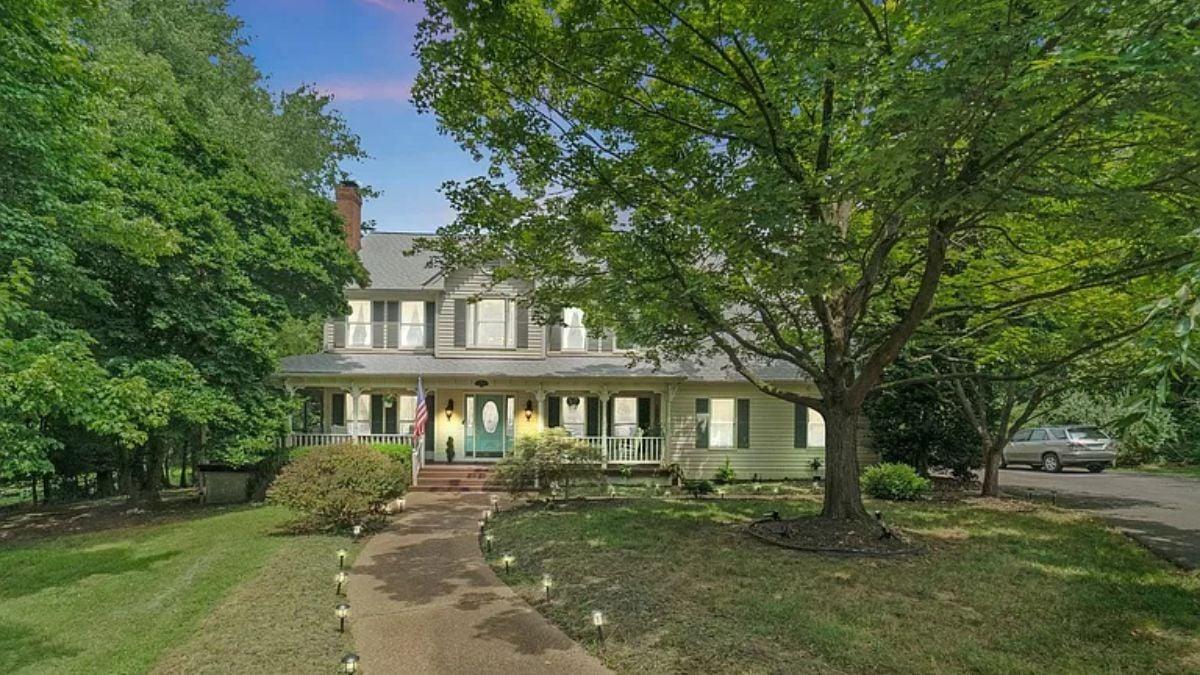 Quaint Family Home with Wrap-Around Porch and Lush Greenery