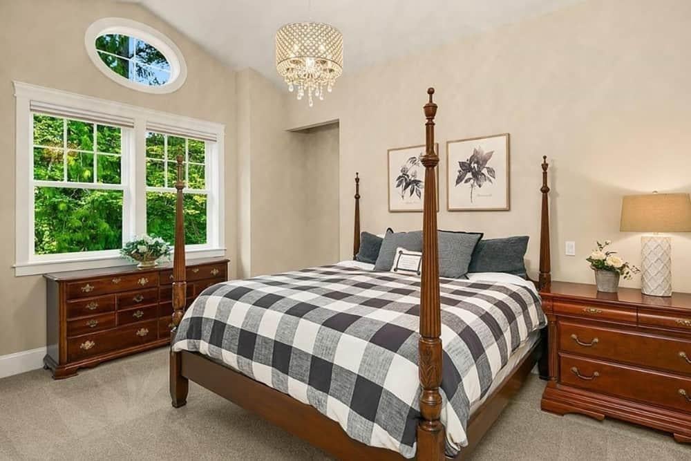 Experience Timeless Appeal with a Four-Poster Bed and Oval Window