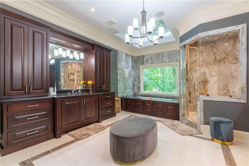 Luxurious Bathroom with Dark Wood Cabinetry and Skylights