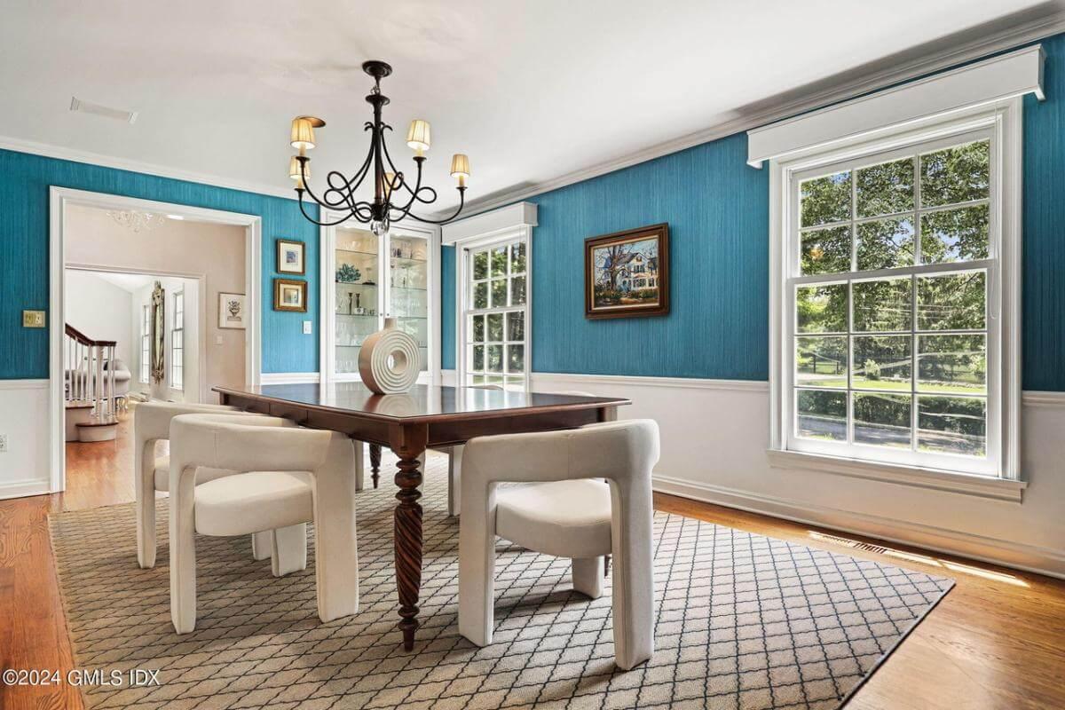 Elegant Dining Room with Striking Blue Walls and Traditional Chandelier