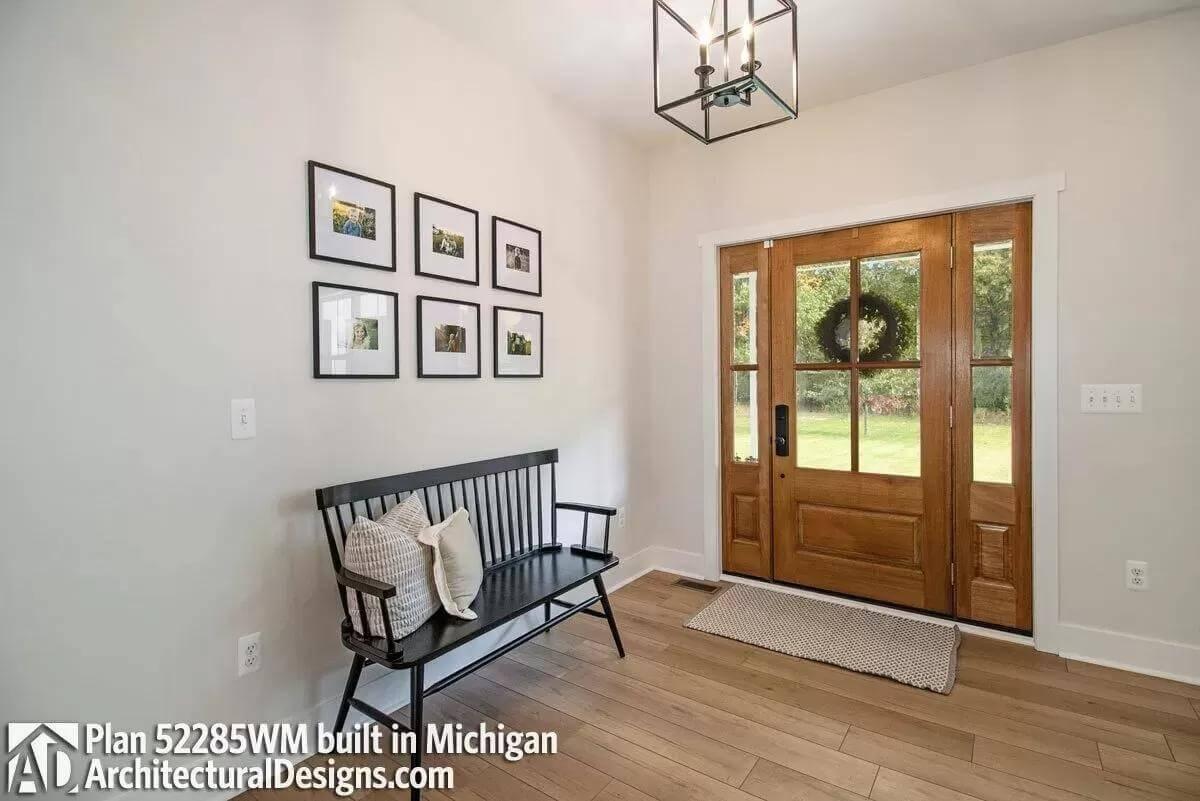 Farmhouse Entryway: A Warm Welcome with a Black Bench and Gallery Wall