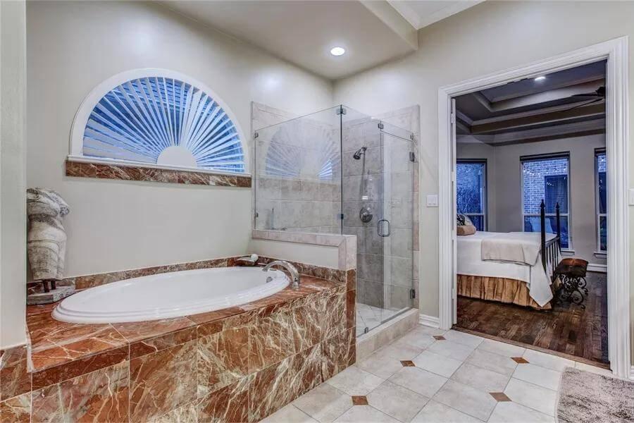 Explore the Luxurious Marble Tub in This Elegant Bathroom Suite