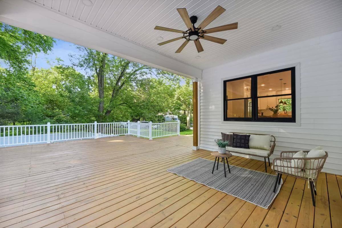 Step onto This Expansive Porch with Natural Wood Decking and Scenic Views