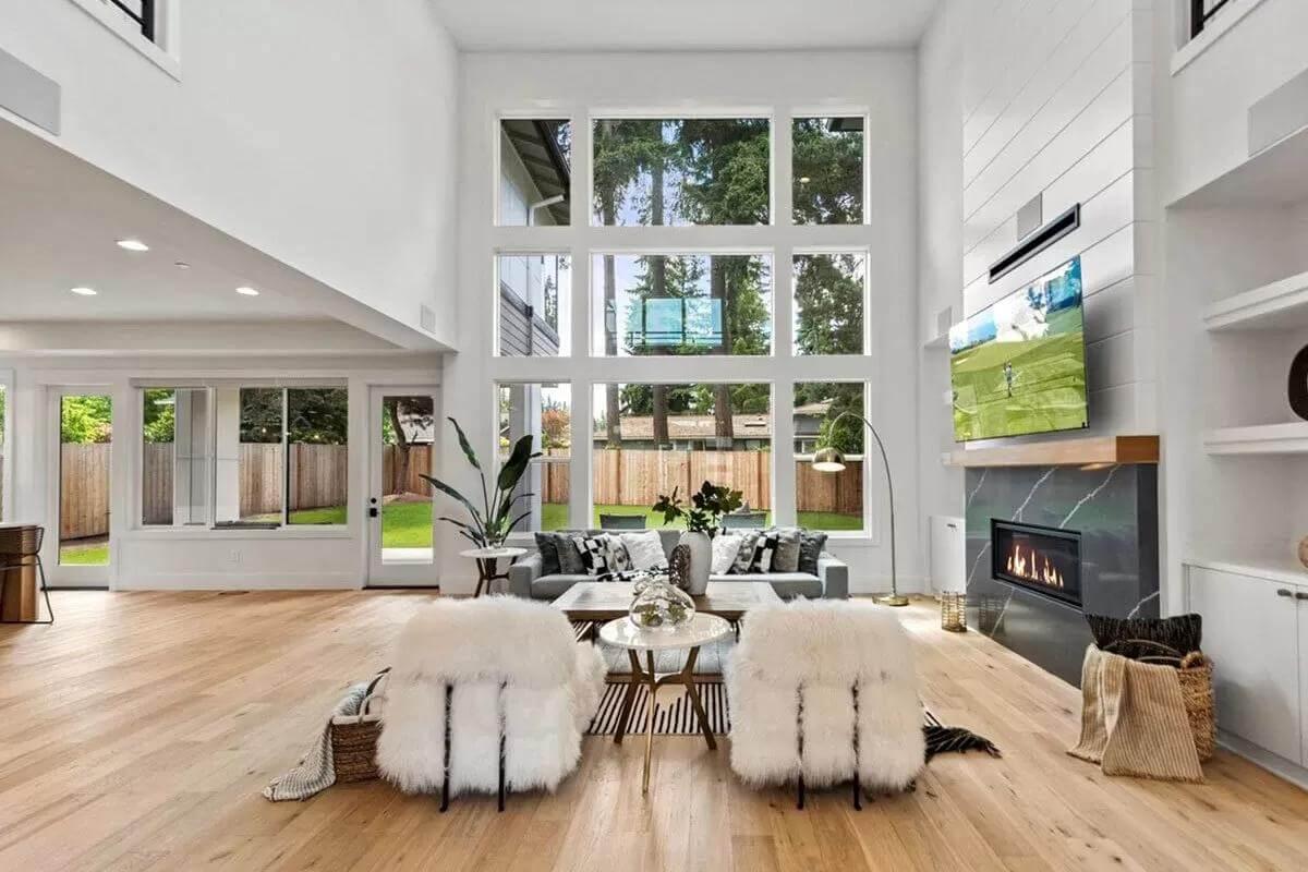 Expansive Living Room with Floor-to-Ceiling Windows and Sleek Fireplace