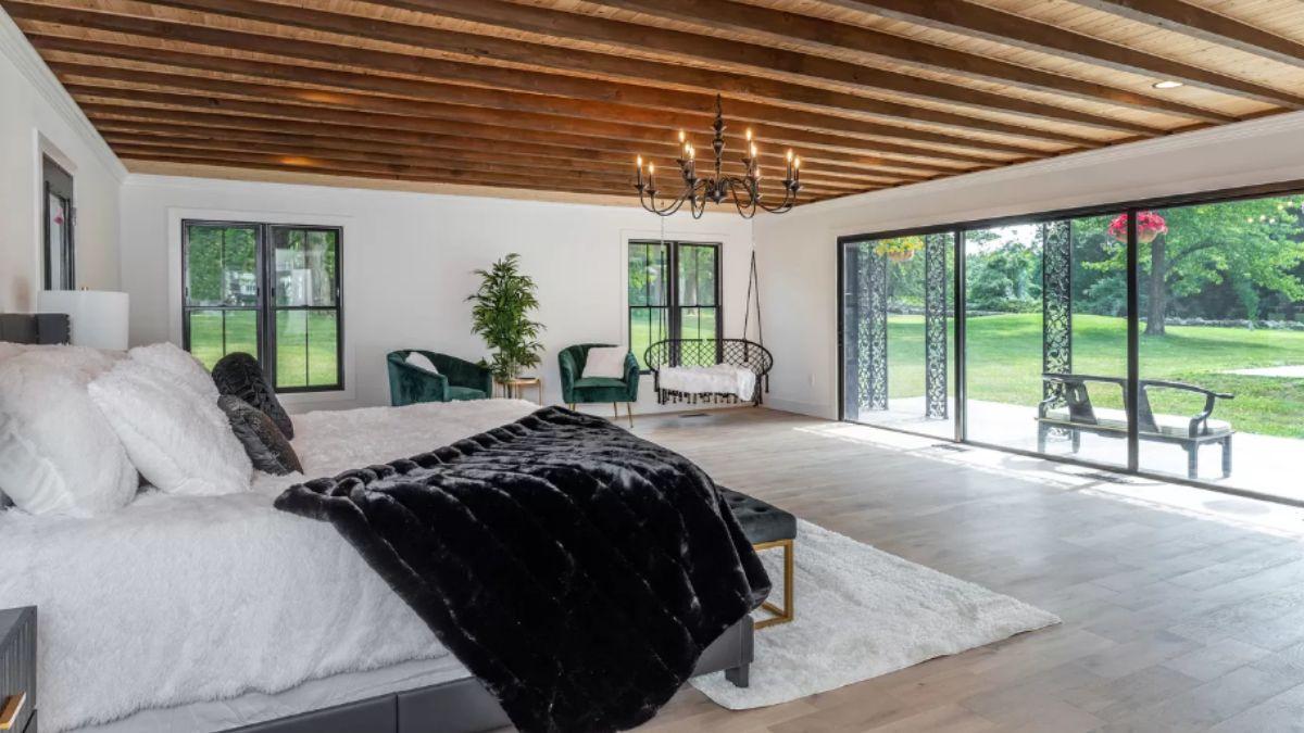 Wow, Look at the Exposed Beam Ceiling and Wall of Windows in This Open Bedroom