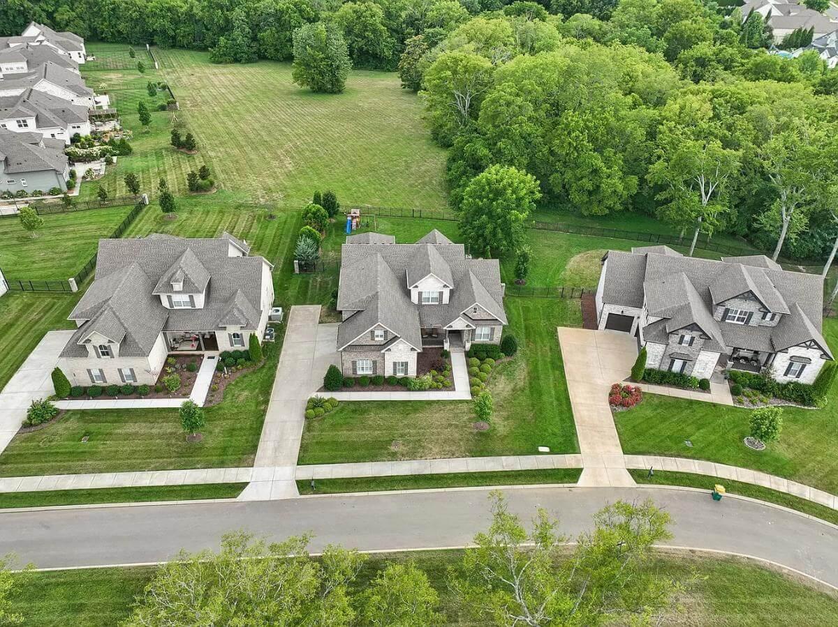 Wow, Look at This Aerial View of Three Classic Homes with Lush Lawns