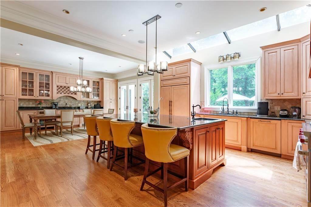 Notice the Warm Wooden Cabinetry and Skylights in This Expansive Kitchen