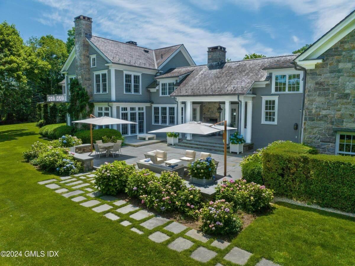 Discover the Serene Patio with Stone Accents and Lush Gardens