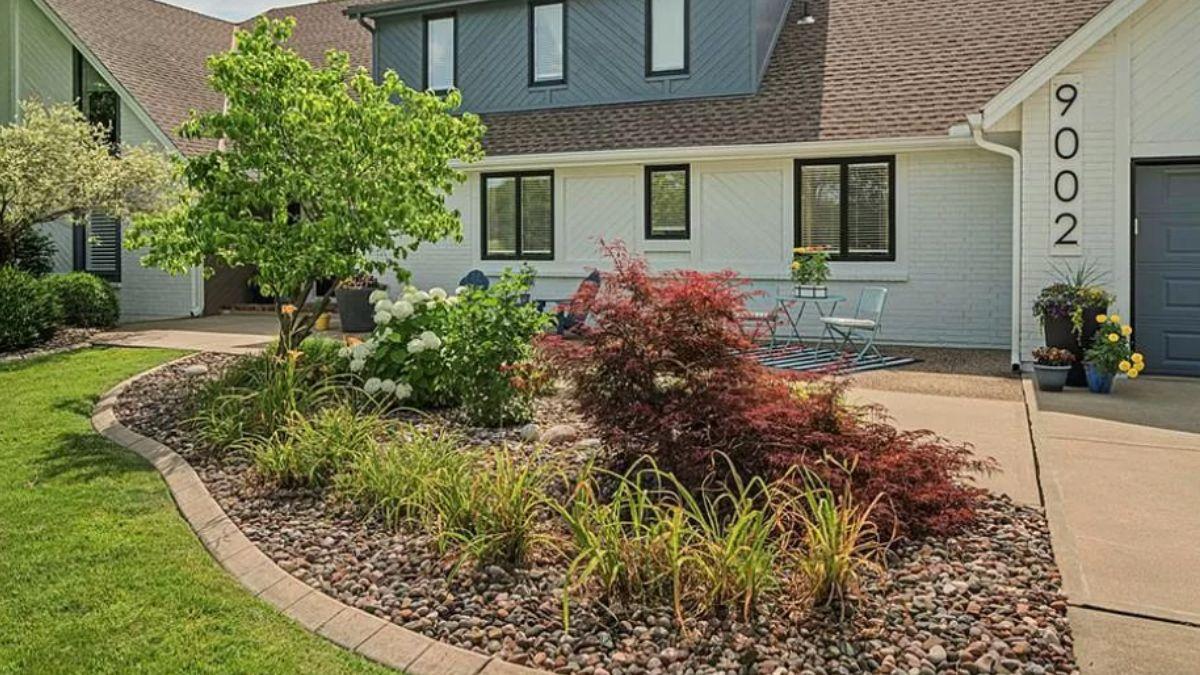 Charming Front Garden with Vibrant Foliage and Cozy Seating