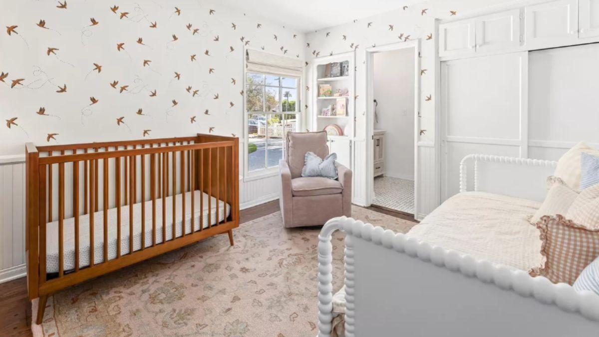 Charming Nursery with Bird Wallpaper and Cozy Accents