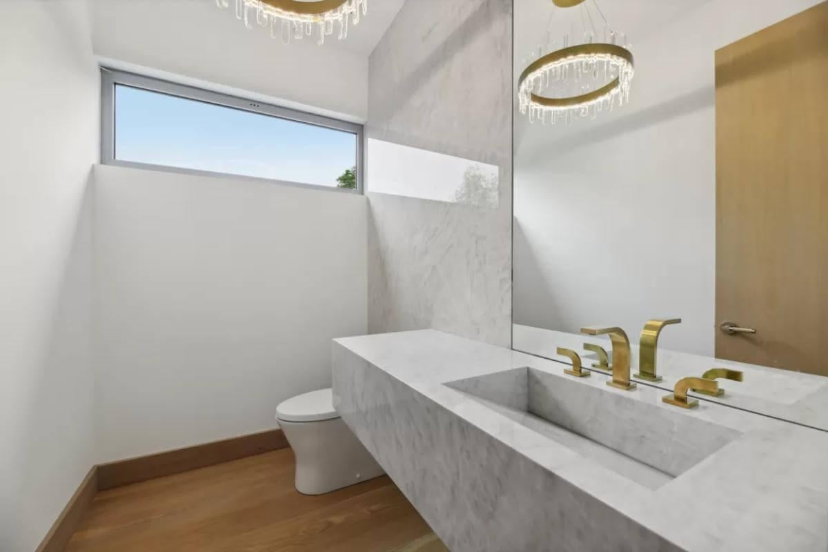 Elegance in Simplicity: Marble Vanity with Brass Fixtures