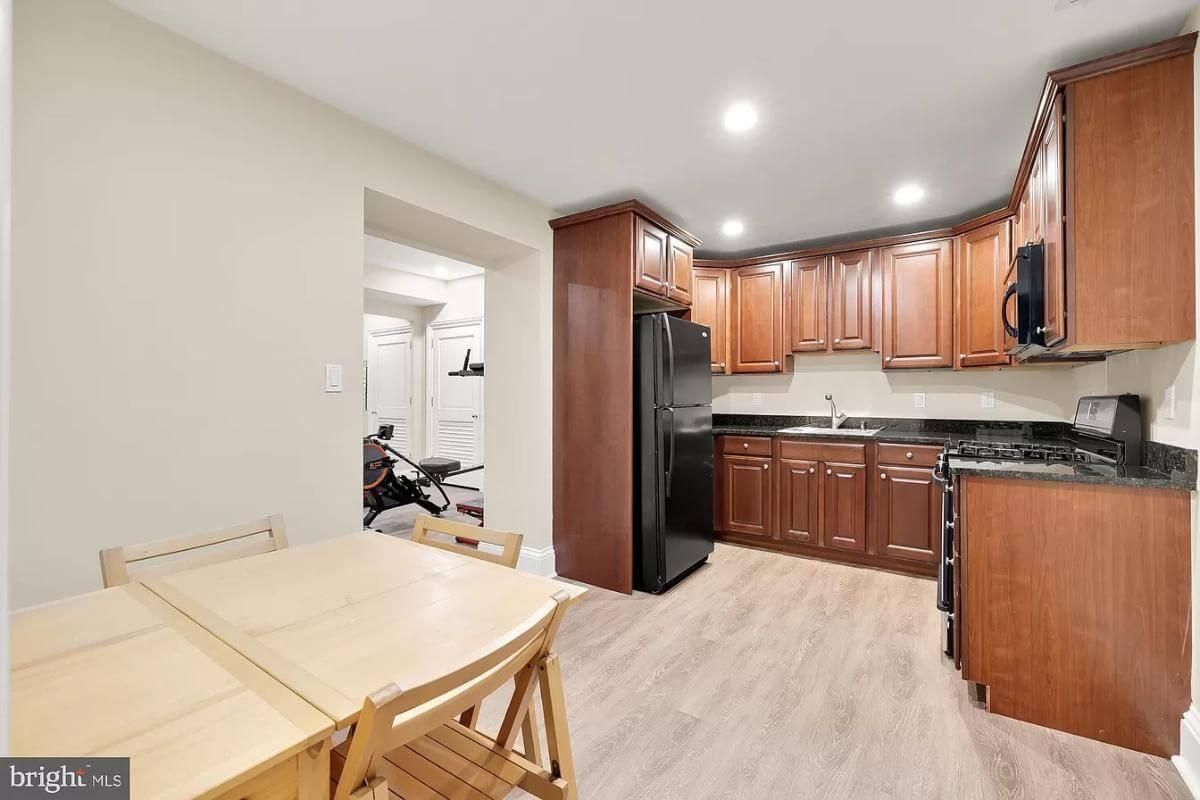 Discover the Warmth of This Basement Kitchen with Rich Wooden Cabinetry