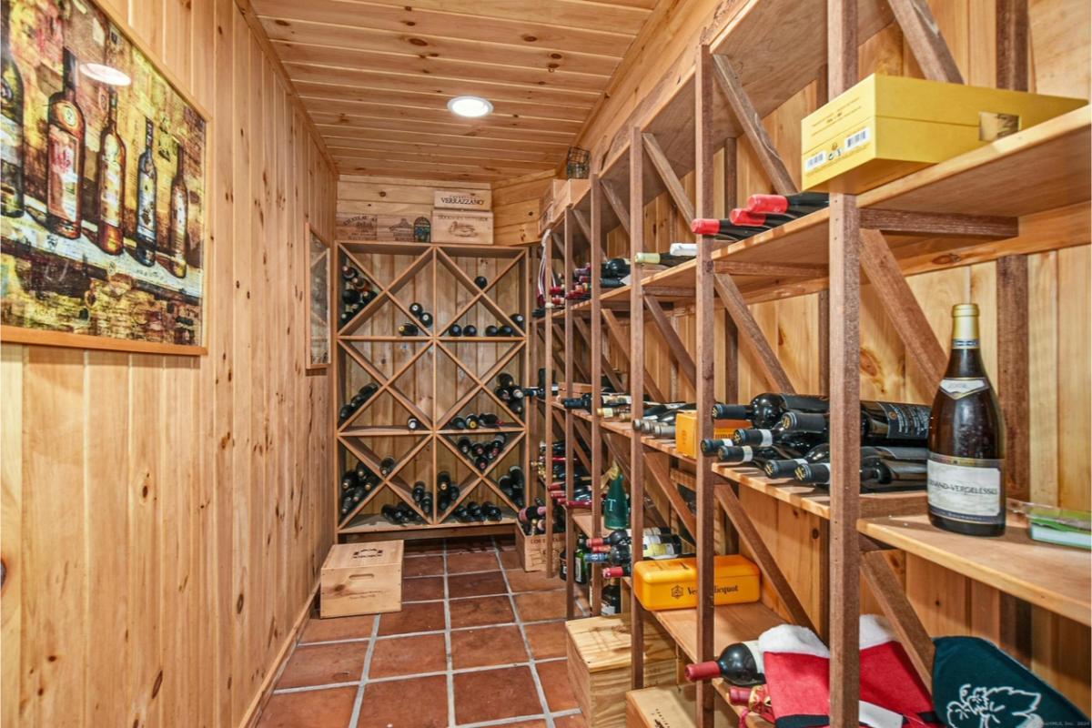Step into This Rustic Wine Cellar with Wooden Racks and Terra Cotta Floor