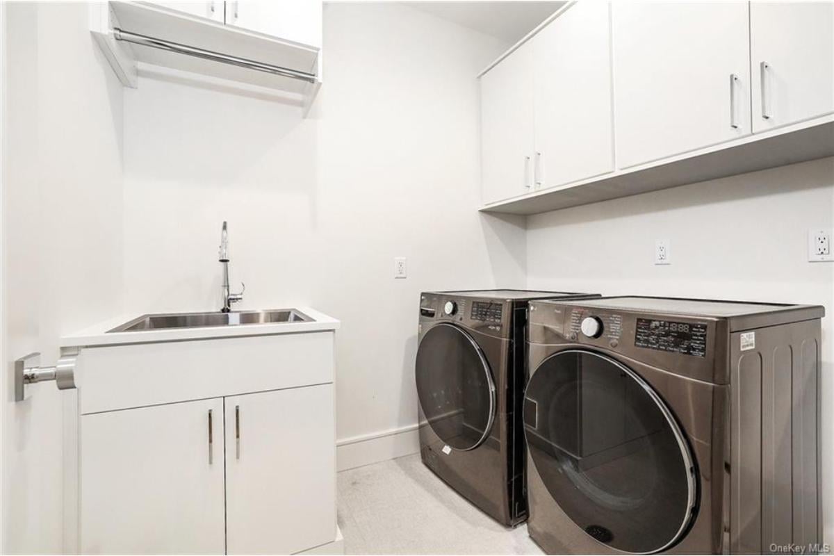 Efficient Laundry Room with Sleek Stainless Steel Sink