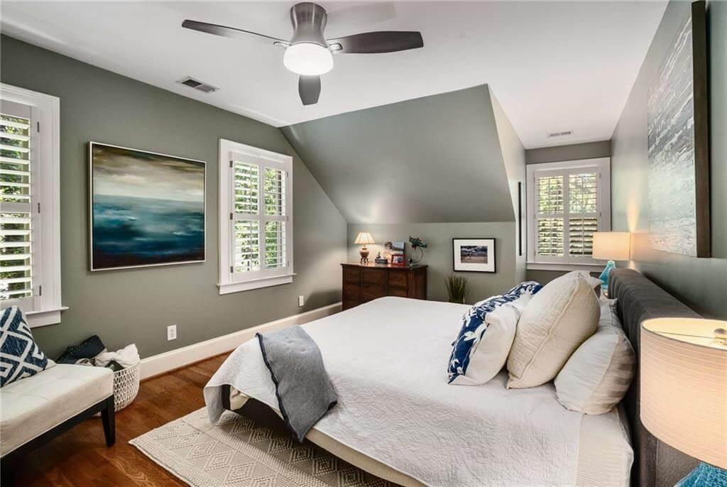 Elegant Bedroom with Sloped Ceiling and Peaceful Green Walls