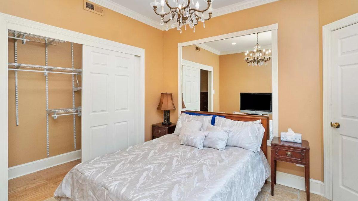Cozy Bedroom with Ornate Lighting and Mirror Accents