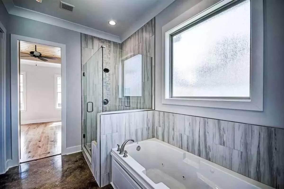 Bathroom Retreat with Textured Walls and a Glass Shower