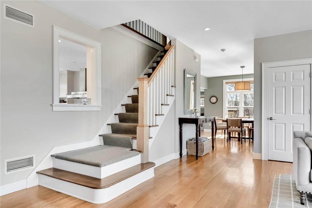 Notice the Carpeted Staircase Leading to a Sunlit Dining Area