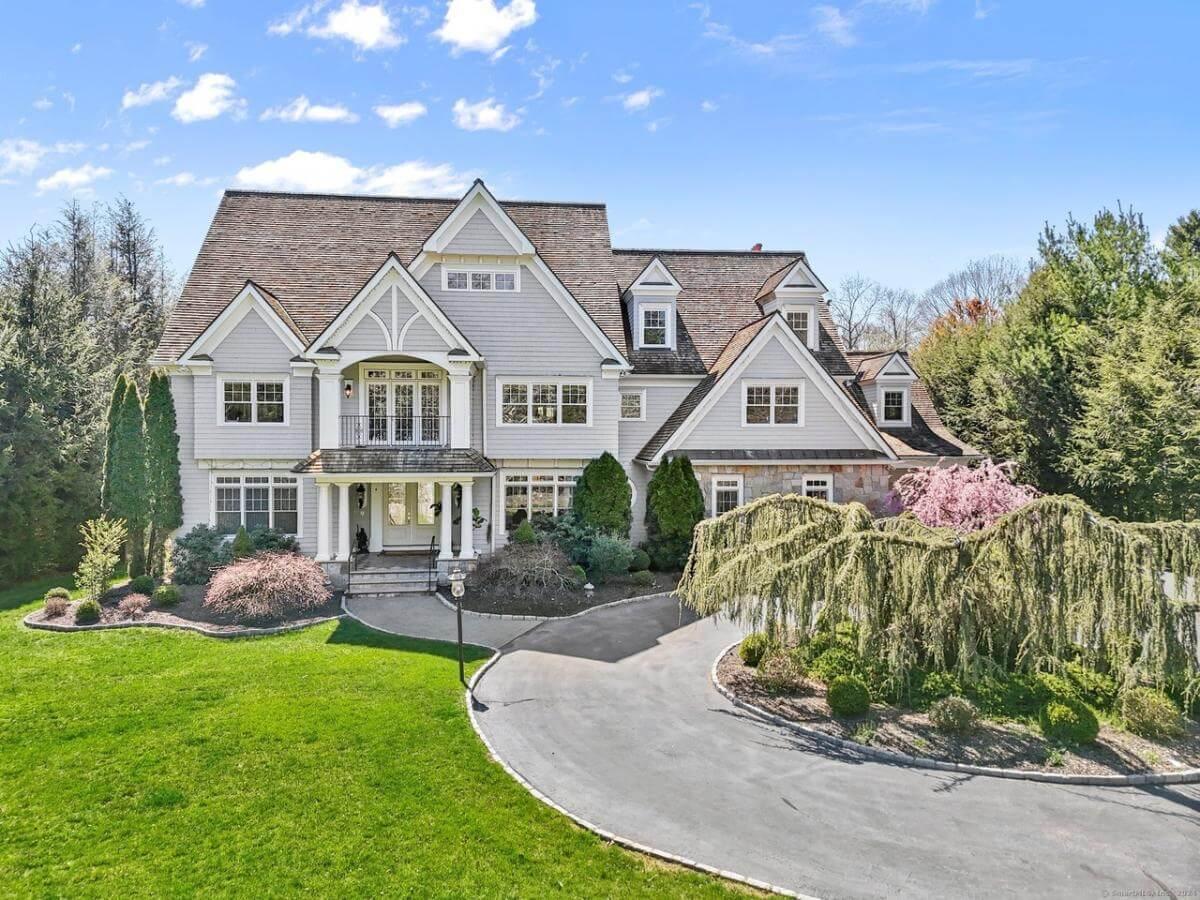 Grand Craftsman Facade with Detailed Gables and Lush Landscaping