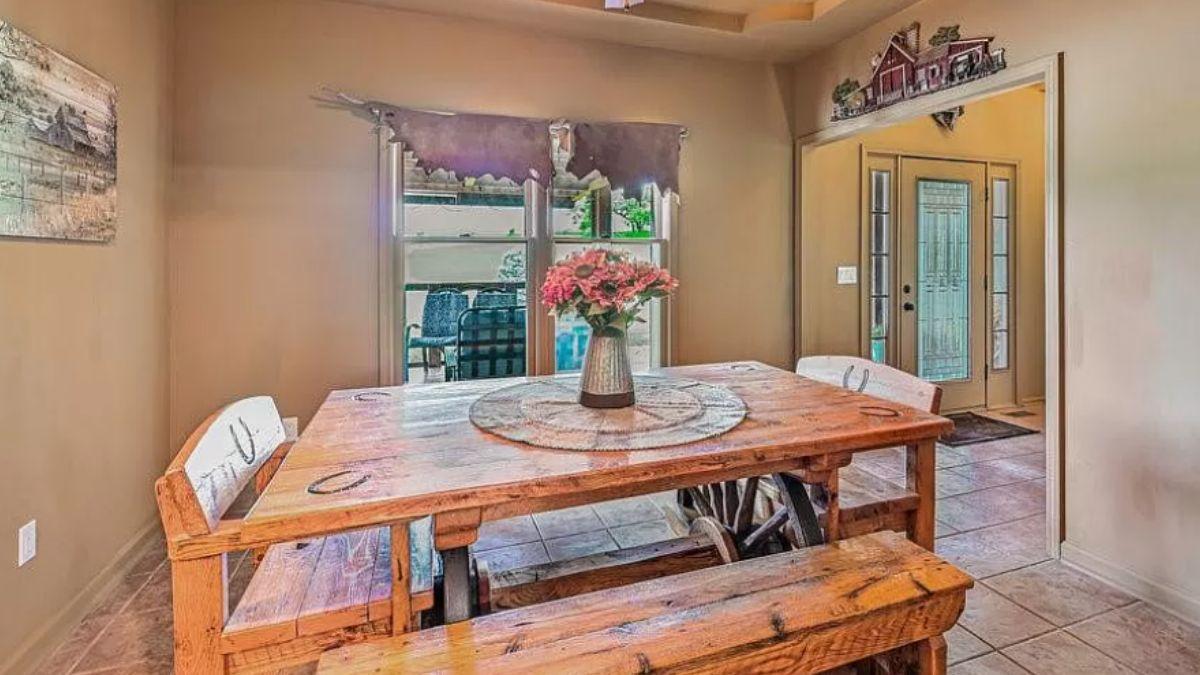 Rustic Dining Nook with Farmhouse Decor and Unique Window Treatment