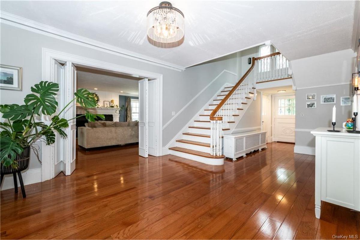 Step Into This Inviting Foyer with Rich Wooden Floors