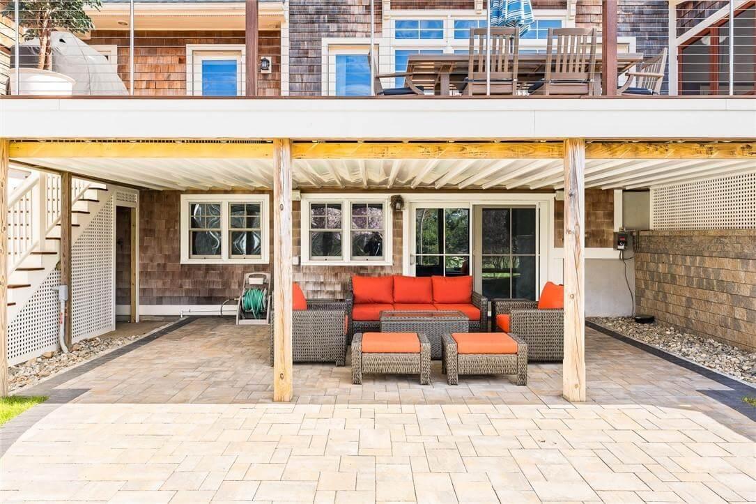 Enjoy This Covered Patio Retreat with Bold Orange Accents
