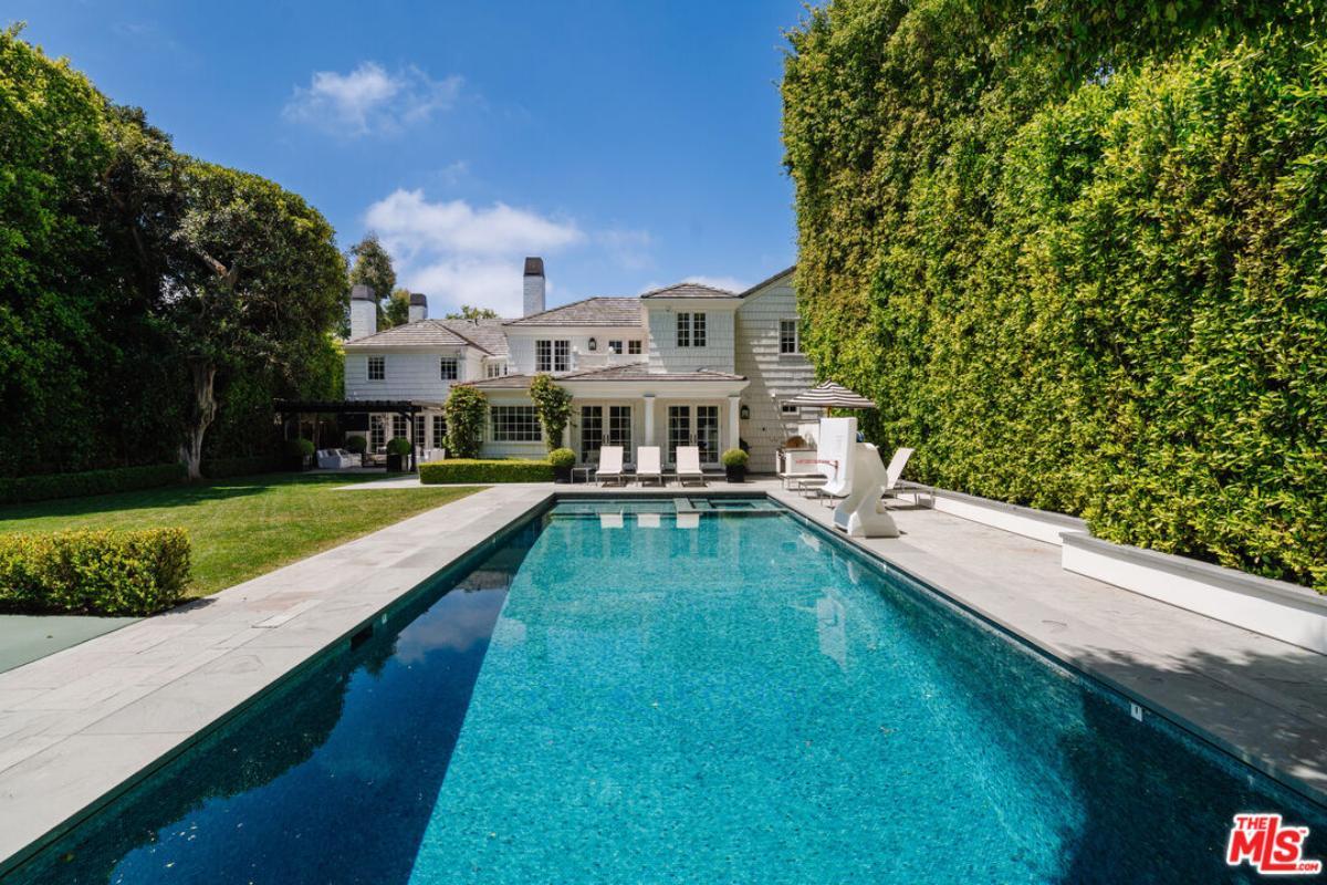 Lap Pool Oasis with Elegant White Facade and Privacy Hedges