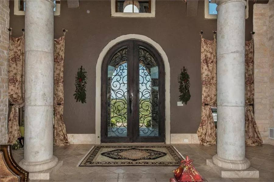 Step into Elegance with This Arched Iron Entryway
