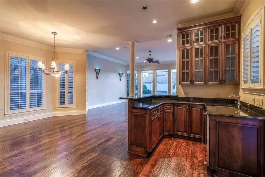 Discover the Integration of the Kitchen and Living Space with Dark Wood Detailing