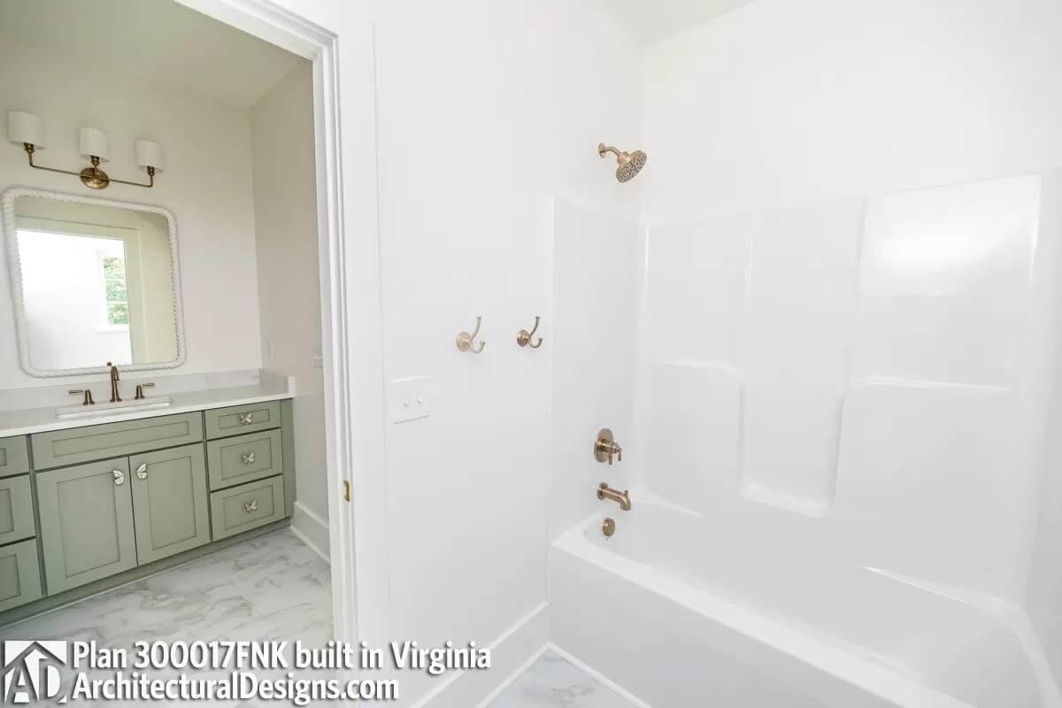 Take a Look at This Bathroom with Sage Green Vanity and Brass Fixtures