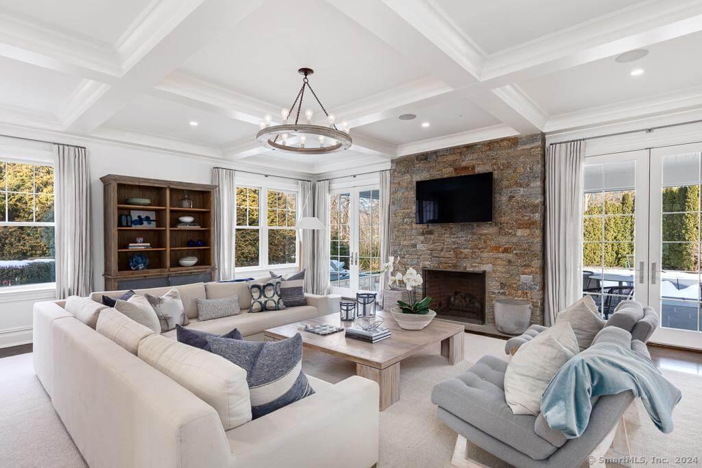 Relaxing Family Room with Stone Fireplace and Coffered Ceiling