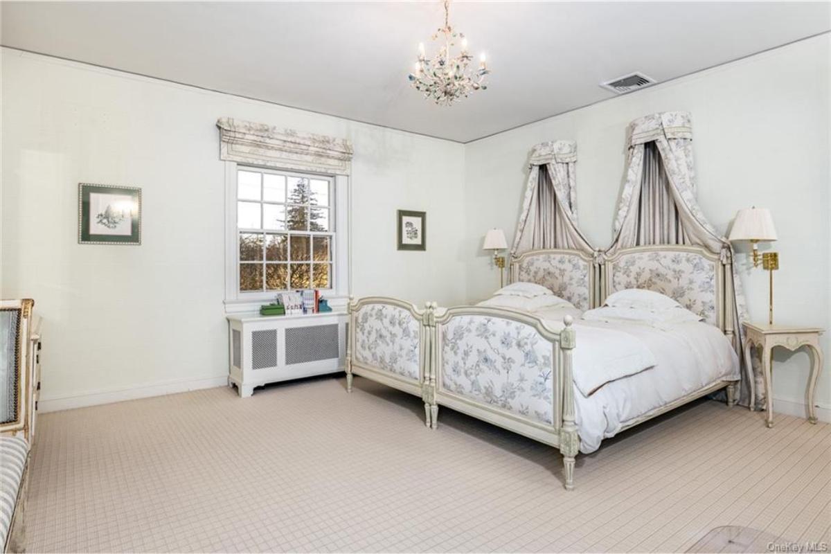 Graceful Bedroom with Elegant Canopy Beds and Floral Accents