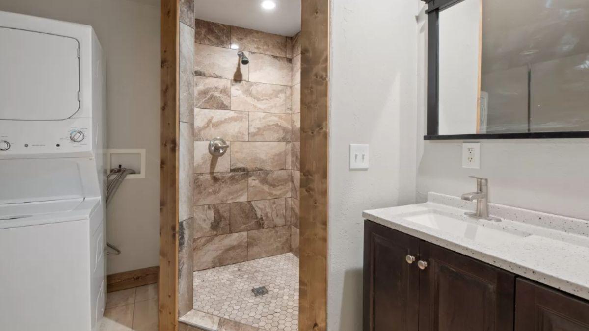 Spot the Rustic Shower Trim and Convenient Laundry Setup
