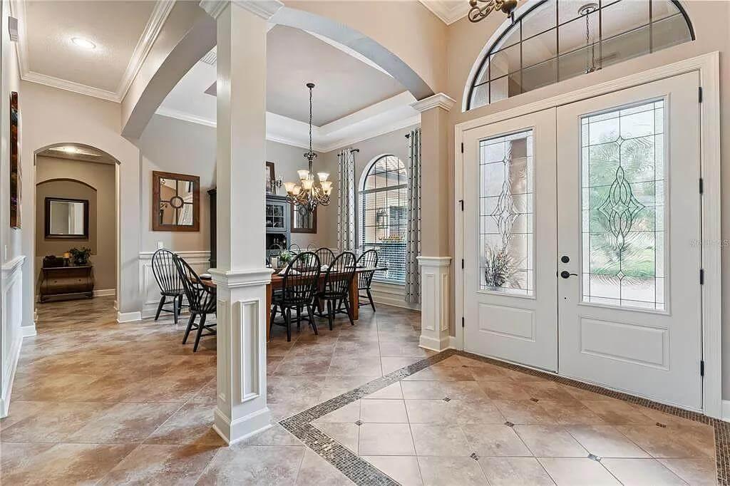 Spacious Dining Area with Arched Accents and Glass Detailing