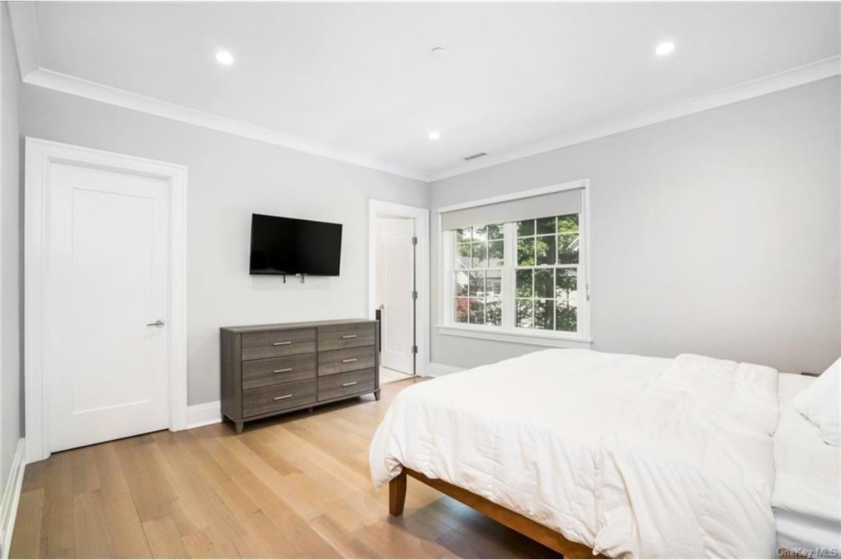 Simple Elegance in a Minimalist Bedroom with Large Windows