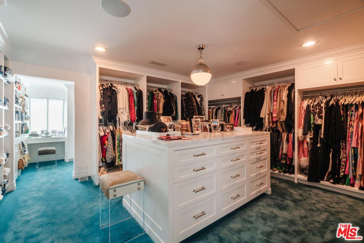 Luxurious Walk-In Closet with Central Island and Plush Carpet