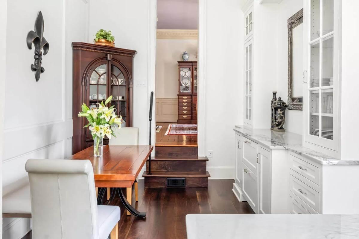 White Cabinetry Meets Traditional Dark Wood in a Transitional Space