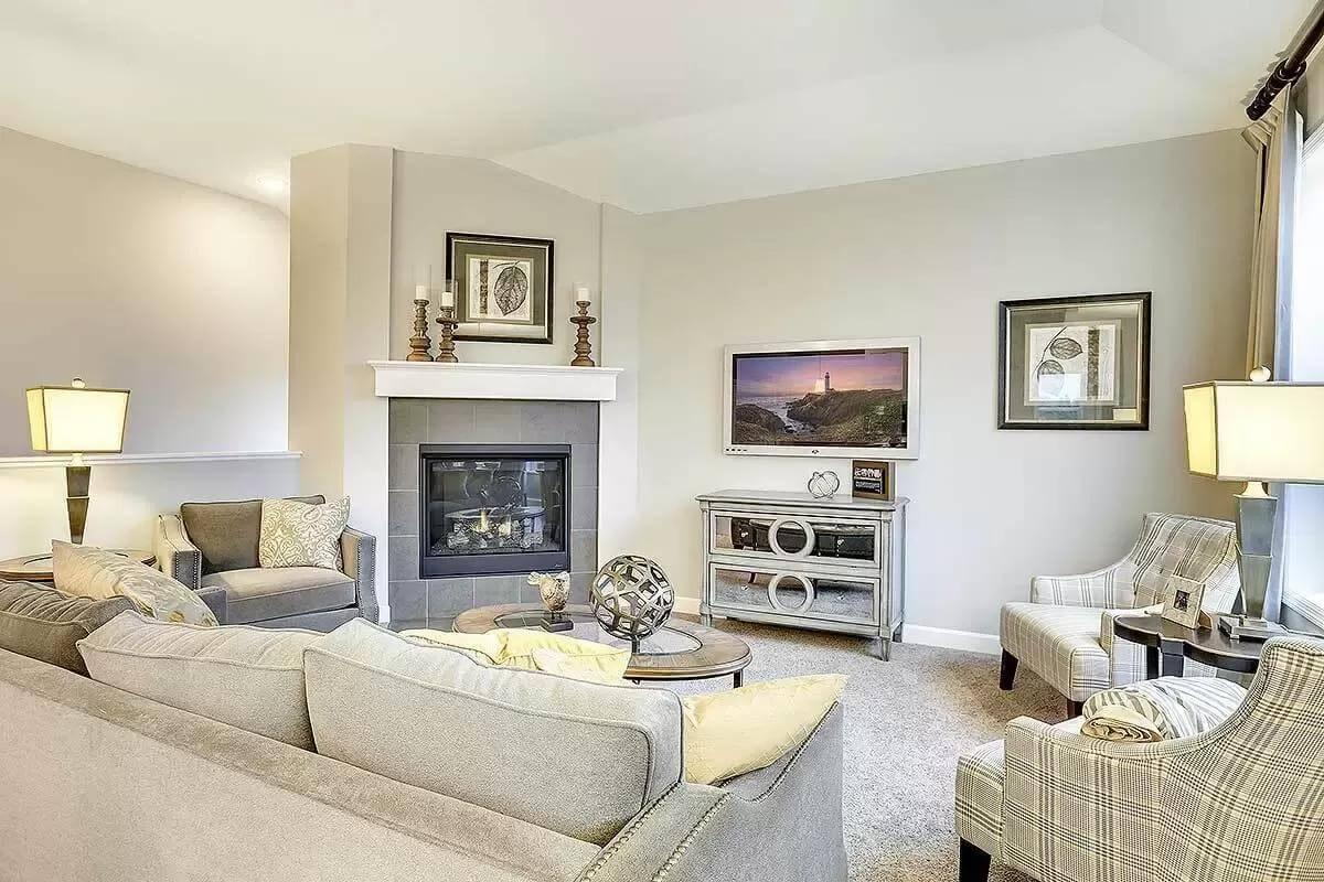 Sophisticated Living Room with a Corner Fireplace and Artful Decor Pieces