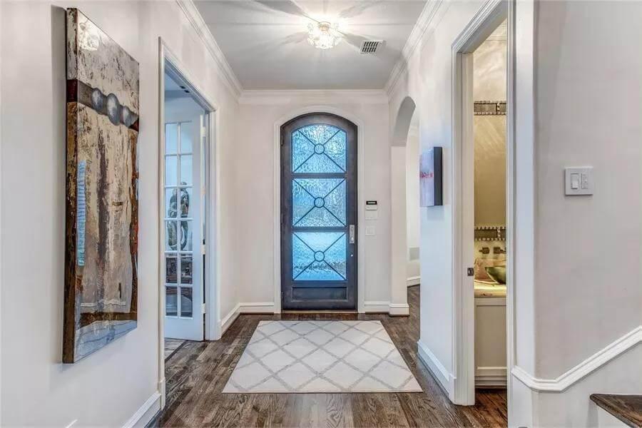 Welcoming Entryway with Artful Details and Glass Door