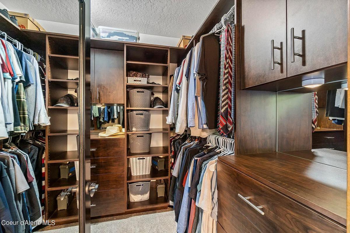 Step Inside This Thoughtfully Organized Walk-In Closet with Rich Wood Finishes