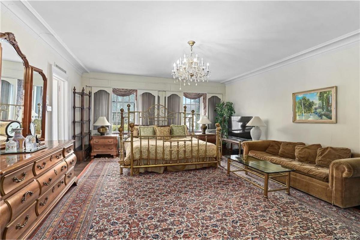 Vintage Master Bedroom with Ornate Chandelier and Luxurious Details