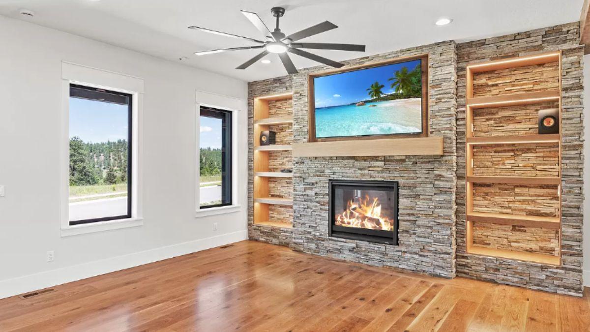 Warm Living Room with a Stone Fireplace and Built-In Shelving