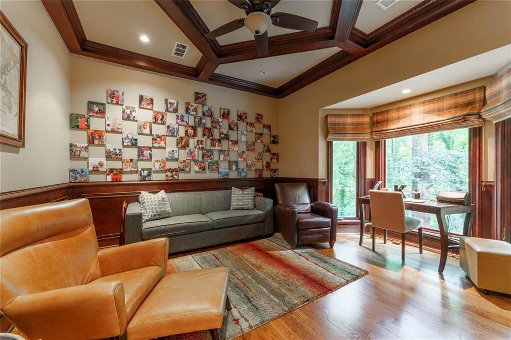 Check Out the Wooden Coffered Ceiling and Family Photo Wall in This Cozy Den
