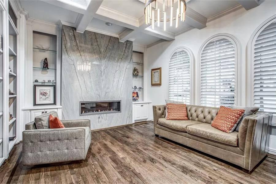 Sophisticated Sitting Room with Marble Fireplace as the Centerpiece